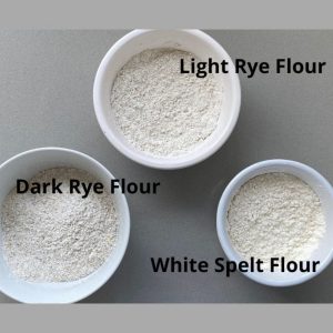 Rye and Spelt Flour in white dishes.