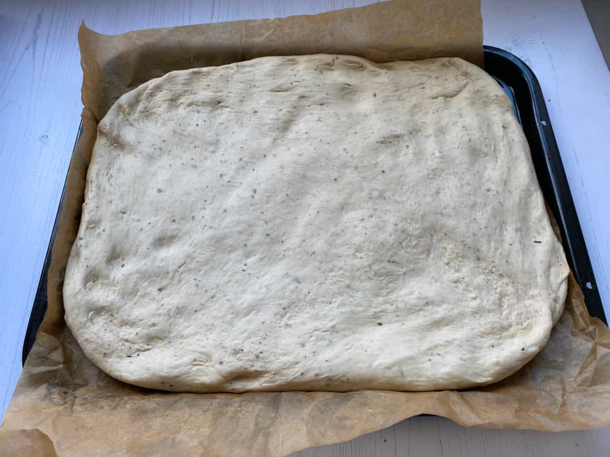 Spread out the Focaccia dough on a baking tray.
