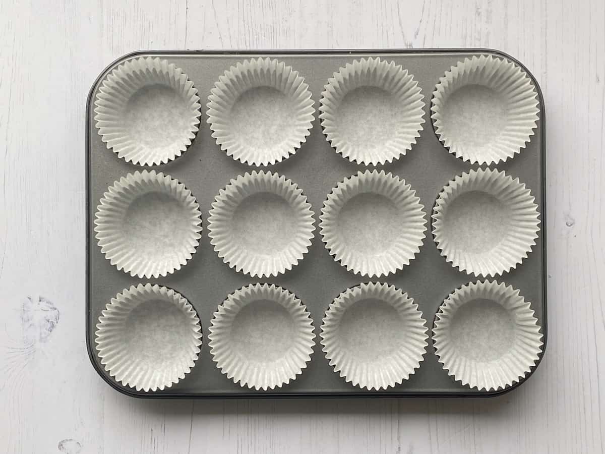 12 paper muffin cases in a Muffin Tin.