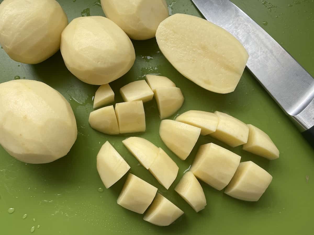 Chopped potatoes on a green board.