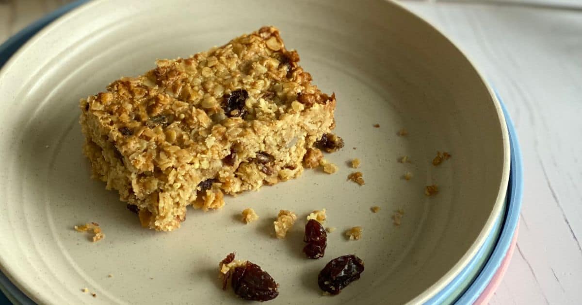 Slice of Fruit and Seed Flapjack on a small plate. 